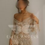 Africa Luxury Escort Barcelona wearing a white dress